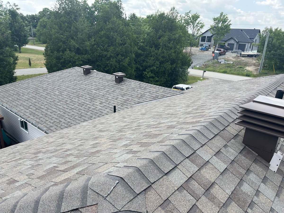 Driftwood shingle roof installation with clean edge and eave detail